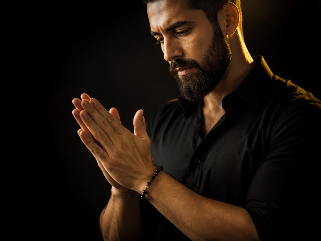 Rubbing palms together to warm beard oil before applying